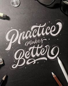 the words practice makes better written on a blackboard with pens and glasses next to it