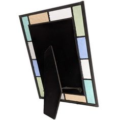 a multicolored stained glass photo frame on a white background with an arrow sticking out of it