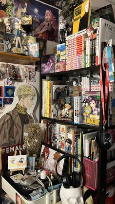 a bookshelf filled with lots of anime related items next to a wall covered in pictures