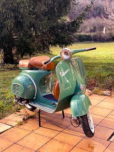 a green scooter is parked on the sidewalk