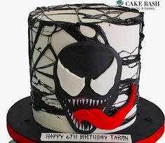 a spiderman birthday cake is decorated with black and white icing, spooked out