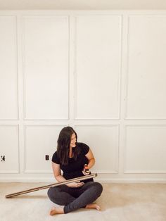 a woman is sitting on the floor with her hair dryer in front of her