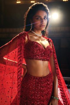 Red lehenga with attached can-can, sequin embroidery in a leaf pattern and cutwork detail on the hem. Comes with sleeveless padded blouse and sheer dupatta.
Component: 3
Pattern: Embroidery
Type Of Work: Sequin
Neckline: Sweetheart
Sleeve Type: Sleeveless
Fabric: Net
Color: Red
Other Details: 
Sheer dupatta with embroidered border
Blouse with bead drops
Sequin embroidery on the blouse
Occasion: Bride - Aza Fashions Glamorous Diwali Sets With Traditional Drape, Glamorous Traditional Drape Sets For Diwali, Festive Glamorous Sets With Sheer Dupatta, Glamorous Festive Set With Sheer Dupatta, Glamorous Festive Sets With Sheer Dupatta, Glamorous Navratri Sets With Traditional Drape, Glamorous Festive Saree Set, Glamorous Choli With Zari Work For Celebration, Red Party Wear Set With Dupatta