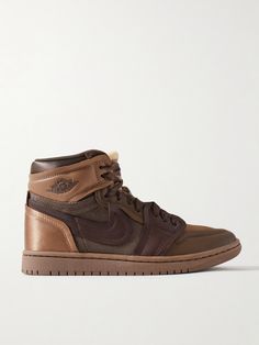 Nike's 'Method of Make' line takes iconic sneakers and elevates them with luxurious materials and details. Part of the series, this 'Air Jordan 1' pair is made from layered panels of leather, twill and satin in a rich tonal-brown colorway. Show off the high-top silhouette with shorts or cropped pants. Nike Leather Sole Sneakers With Round Toe, Luxury Brown Leather High-top Sneakers, Nike Leather Sneakers With Leather Sole, Modern Leather High-top Sneakers With Boost Midsole, Luxury Leather High-top Sneakers With Rubber Sole, Leather Sneakers With Boost Midsole, Medium Fit, Nike Luxury Leather Sneakers, Luxury Nike Custom Sneakers For Streetwear, Brown Leather Sneakers With Boost Midsole