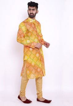 Readymade Art Kota Silk Front Open Kurta in Shaded Yellow and Orange. This Collar Neck and Full Sleeve attire is Prettified with Buttons, Bandhej and Foil Print and has Two Side Pockets. Available with an Art Silk Churidar in Beige. Do note: Footwear shown in the image is for presentation purposes only. Half to one inch may vary in measurement. (Slight variation in actual color vs. image is possible). Yellow Printed Long Sleeve Kurta, Yellow Printed Long-sleeve Kurta, Fitted Patterned Sets For Festive Occasions, Transitional Yellow Bandhani Print Sets, Long Sleeve Multicolor Kurta With Self Design, Multicolor Long Sleeve Kurta With Self Design, Fitted Patterned Kurta For Festive Occasions, Traditional Orange Printed Sets, Multicolor Bandhani Print Kurta For Transitional Season