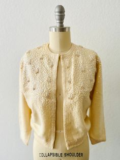 Vintage 50s Chantilly Cream Angora cardigan-Iridescent sequin beaded with Tassels-Hook and eye front closure-3/4 sleeve with silk lining Size:  XS, S Condition:  Good vintage condition, collar has been reinforced with sewn ribbon Embellished Sweater For Spring Party, Elegant Sequin Sweater, Spring Party Embellished Sweater, Elegant Winter Cardigan With Sequins, Embellished Fitted Cardigan For Party, Elegant Sequined Cardigan For Fall, Elegant Sequined Sweater For Fall, Fitted Glamorous Winter Sweater, Glamorous Fitted Sweater For Winter