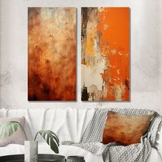 two paintings on the wall in a living room