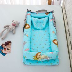 a baby's bed and stuffed animals on a table