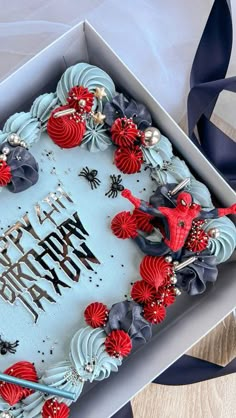 a birthday cake in a box with red and blue decorations