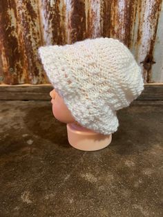 a white knitted hat on top of a mannequin head