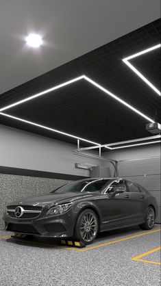 a car parked in a parking garage with lights on the ceiling and overhead lighting above it