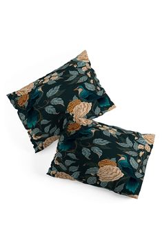 two pillows with floral designs on them, one is green and the other is blue