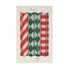 four christmas candles are lined up in a row and one is red, green and white