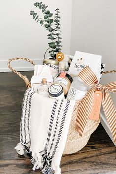 a basket filled with personal care items on top of a wooden floor next to a potted plant