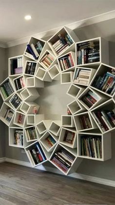 a circular book shelf filled with lots of books in the middle of a living room