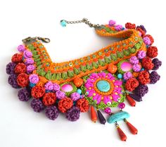 This beautiful contemporary crochet necklace is the perfect blend of modern style and ethnic influence. The intricate crochet work is inspired by traditional techniques, with a bold and vibrant color palette that draws from exotic cultures around the world. The necklace is made from high-quality materials(cotton, viscose), ensuring that it is durable and long-lasting. It incorporates lots of sand beads, glass beads, artificial turquoise and mother of pearl. It is also very lightweight for its si Multicolor Crochet Bohemian Jewelry, Unique Multicolor Macrame Jewelry, Bohemian Crochet Necklaces For Festivals, Bohemian Crochet Necklace For Festivals, Unique Multicolor Boho Collar Jewelry, Bohemian Multicolor Macrame Necklaces, Bohemian Multicolor Macrame Necklace, Handmade Vibrant Beaded Necklaces For Festivals, Vibrant Handmade Beaded Necklaces For Festivals