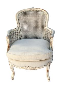 an old fashioned chair with a white cushion