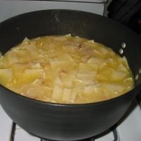 a pot filled with food sitting on top of a stove