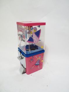 a pink and blue ice cream vending machine with an umbrella on it's top