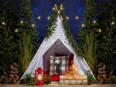 a teepee tent in the woods with christmas decorations