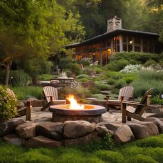 a fire pit in the middle of a garden with chairs around it and a house in the background