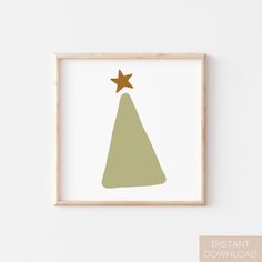 a green christmas tree with a gold star on top, framed in a wooden frame