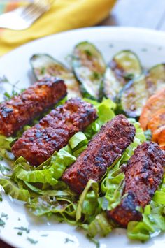 a white plate topped with meat and veggies