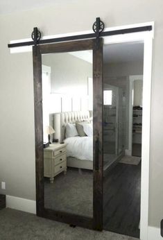 a bedroom with a large mirror on the wall