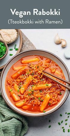 a bowl of vegan ramen with carrots and noodles in red broth