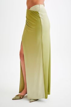 For a summer escapade.The BRONWYN Slinky Ruched Maxi Skirt With Split is a sophisticated and stylish piece designed to make a statement. Featuring a mid-rise fit and a flattering V front, this skirt enhances your natural curves. The centre front split adds a touch of allure, while the ruching at the side seams provides a chic, textured look. Made with stretch fabrication, it ensures comfort and ease of movement. For a complete and stunning outfit, pair this skirt with the Bronwyn Slinky Halter C Capsule Wardrobe Accessories, Skirt With Split, Capsule Wardrobe Basics, European Summer Outfits, Wardrobe Accessories, Capsule Outfits, Beige Dresses, Stunning Outfits, Natural Curves