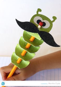 an apple slice with a mustache on it and a pencil sticking out of the top