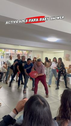 a group of people are playing with a frisbee in the middle of a room