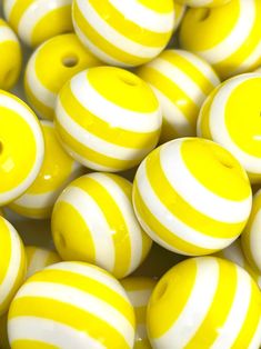 yellow and white striped beads with holes in them