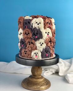 there is a cake decorated with many dogs on the top and bottom, as well as white frosting