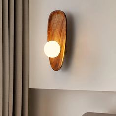 a wooden light mounted on the wall above a bed