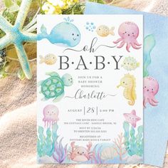 an ocean themed baby shower is on the sand with starfish and seahorses