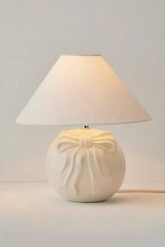 a white lamp with a bow on it