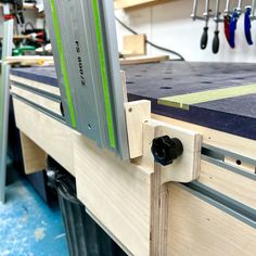 a workbench with tools hanging from it's sides and some screws