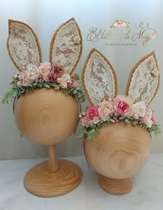 two wooden vases decorated with flowers and bunny ears