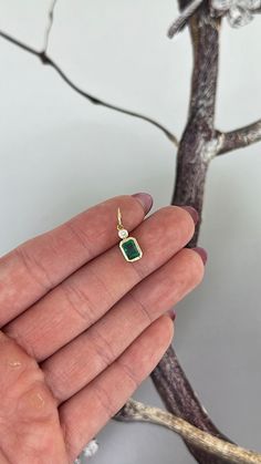 Introducing our emerald and diamond bezel charm, the perfect addition to enhance any necklace. Featuring a large jump ring, this charm easily transfers between necklaces for endless combinations. Versatile and elegant, it can even be added to a bracelet for a touch of luxury. Available in 14k Yellow Gold, White Gold or Rose Gold Made to order. Lead time is 3-4 weeks. Benefits of Solid 14k Gold Jewelry Most loved for its durability and longevity Can be worn daily and requires less maintenance and Fine Jewelry With Bezel Setting And Dangle Style, Fine Jewelry With Bezel Setting Dangle, May Birthstone Pendant Jewelry With Charms, Elegant Green Charms For Gifts, Classic Emerald Necklace In 14k Gold With Bezel Setting, Elegant Jewelry With Square Pendant Charms, Elegant Sterling Silver Gemstone Charms, Elegant Emerald Pendant Necklace With Bezel Setting, Emerald Pendant Necklace With Bezel Setting