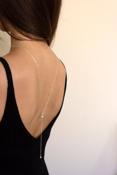 This simple and dainty back drop necklace features two crystalline pearls and looks great with backless tops and dresses. There is no clasp, it is completely reversible, so you can wear it in the front over a sweater or tee. So lightweight - you won't even know it's on! Closure: none Materials: Sterling Silver or 14k Gold Filled Measures 26" ; Drop measures: approx 4" Handmade in New York Arrives perfectly packaged, ready for gift-giving! Poročne Obleke, Christine Elizabeth, Minimal Bride, Fairytale Disney, Wedding Jewelry Simple, Diamond Cross Necklace Gold, Floating Diamond Necklace, White Diamond Necklace, Elizabeth Jewelry