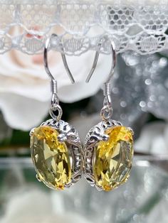 Citrine earrings, yellow citrine earrings with Edwardian sterling silver filigree and traditional wire closures, Silver Embrace Jewelry Classic Yellow Oval Earrings, Yellow Filigree Jewelry, Yellow Oval Citrine Earrings, Yellow Oval Gemstone Earrings, Oval Citrine Gemstone Earrings, Classic Citrine Earrings, Elegant Oval Citrine Earrings, Yellow Earrings With Intricate Design For Gift, Victorian Citrine Yellow Jewelry