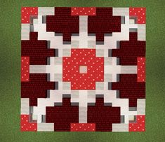 a red and white quilted square with dots on the center, in front of green grass