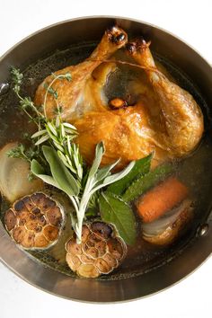 a pan filled with meat and vegetables on top of a table