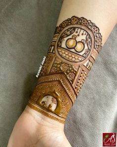 a woman's arm with henna tattoos on it