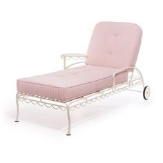 a pink chaise lounge chair sitting on top of a white table