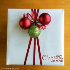 a white plate topped with two red and green christmas bauble ornament