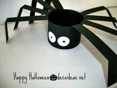 a paper cup decorated like a spider with eyes on it's head and legs