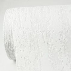 a roll of white toilet paper sitting on top of a table