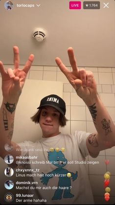 a man with his hands up in the air and two fingers out to spell i love you